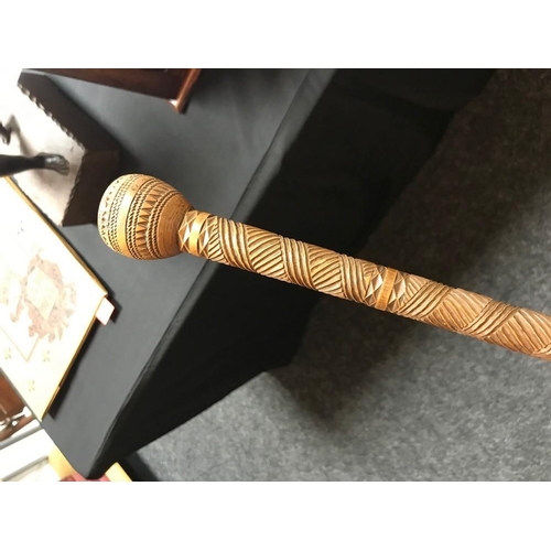 3034 - A 19th century Colonial hardwood gentleman's walking cane, chip carved with geometric motifs, the po... 