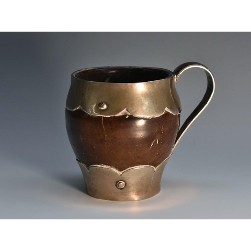 3088 - A 19th century silver coloured metal mounted gourd cup, scroll handle, wavy borders, 7.5cm high