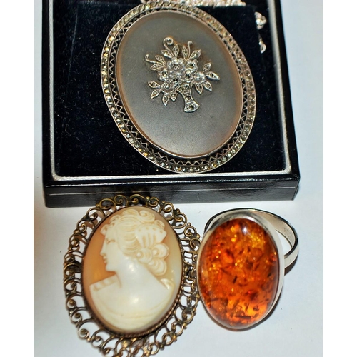 5293 - A silver and marcasite pendant; a silver and composite amber ring; an 800 grade silver mounted shell... 