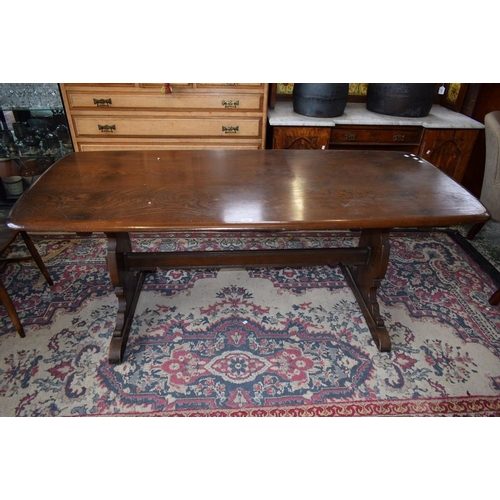 502 - An Ercol elm trestle-type dining table, rounded rectangular top, vasular end supports, 183.5cm long