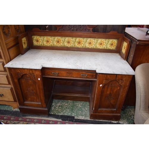 506 - An early 20th century mahogany kneehole washstand, tiled three-quarter gallery back above a substant... 