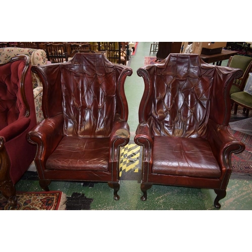 512 - A pair of George III Revival wingback armchairs (2)