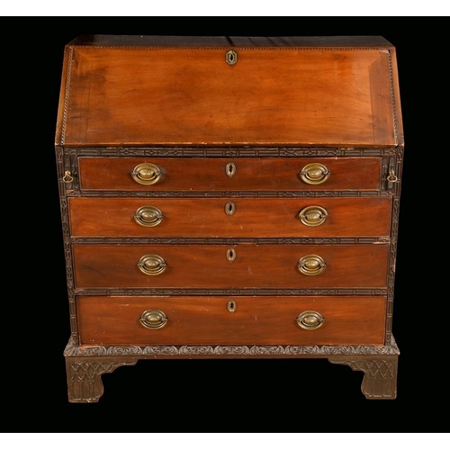 542 - A George III mahogany bureau, fall front enclosing a cupboard, pigeon holes, small drawers, secret c... 