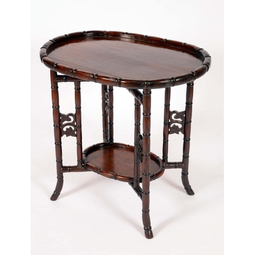 558 - A Chinese padouk wood folding tea table, with two graduated oval trays, carved throughout with leafy... 