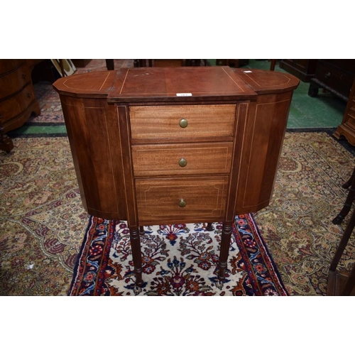 561 - A mahogany work table, the near-square central section with three drawers, the top drawer with a rem... 