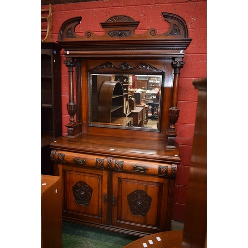 573 - An Arts and Crafts style mahogany mirror-back sideboard, broken arch cresting above a rectangular be... 