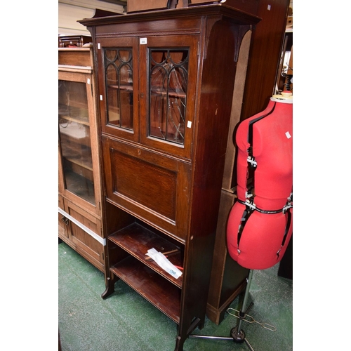 600 - An early 20th century oak bookcase, three-quarter gallery above a pair of glazed doors enclosing two... 