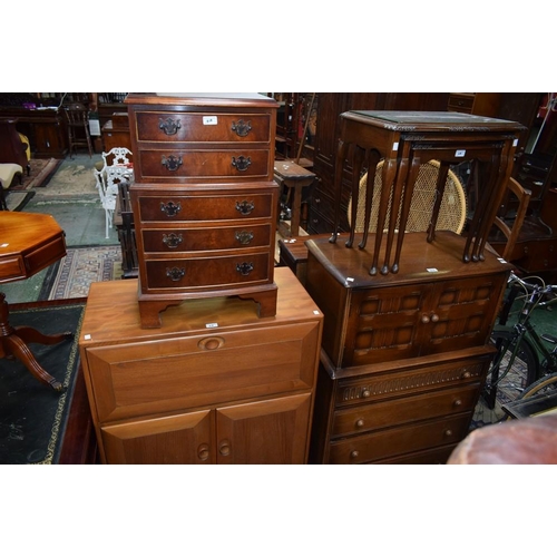 618 - An Ercol style light elm bureau, fall front enclosing a partially segmented interior above a pair of... 