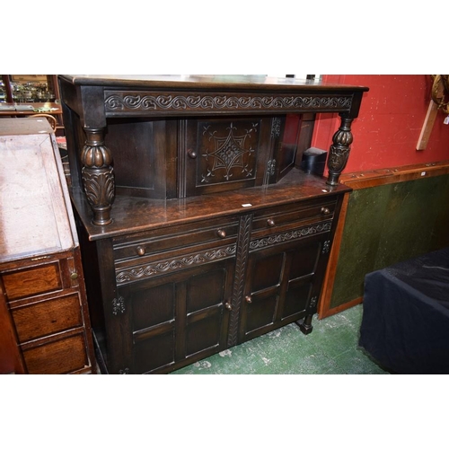 631 - A Priory style oak duodarn/court cupboard, rectangular top above a central panel door, the base with... 