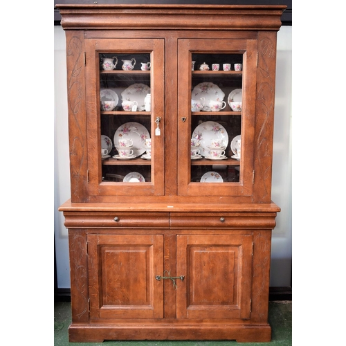 122 - A substantial 20th century oak bookcase, outswept cornice above a pair of glazed doors enclosing thr... 
