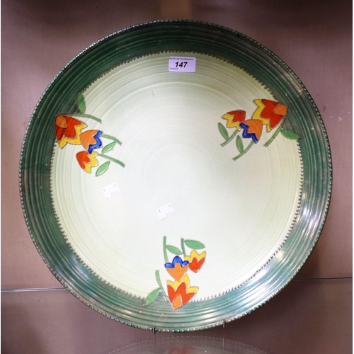 147 - A Crown Ducal charger, orange, blue and yellow stylised flower heads on green ground, 44cm diameter