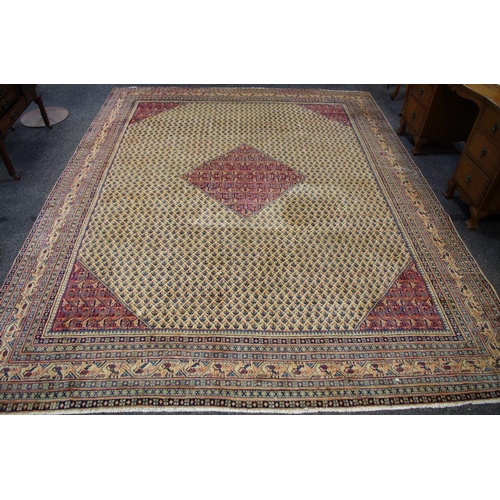 179 - An Araak rug decorated with repeating motifs in cobalt and salmon on a cream ground, banded border w... 