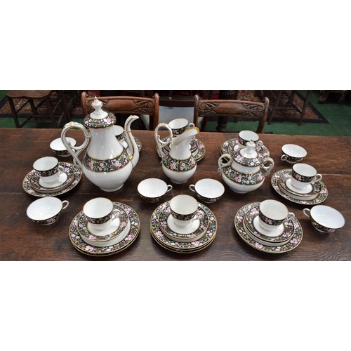 159 - A Bavarian porcelain part breakfast service, banded with pink blossom on matte black ground, compris... 