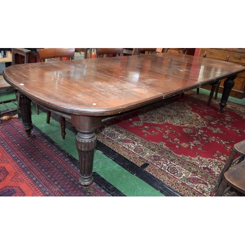 165 - A Victorian mahogany extending dining table, moulded top with wind-out mechanism above a half-bowed ... 