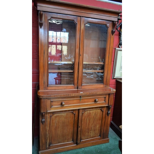 168 - A Victorian mahogany secretaire bookcase, outswept cornice above a pair of glazed doors enclosing an... 