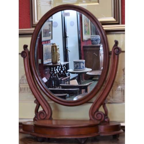 172 - A Victorian mahogany oval dressing table mirror, with hinged compartment, 69cm x 59cm, c.1870