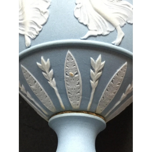 11 - A good pair of Wedgwood Jasperware pedestal ovoid vases and covers, typically sprigged in white with... 