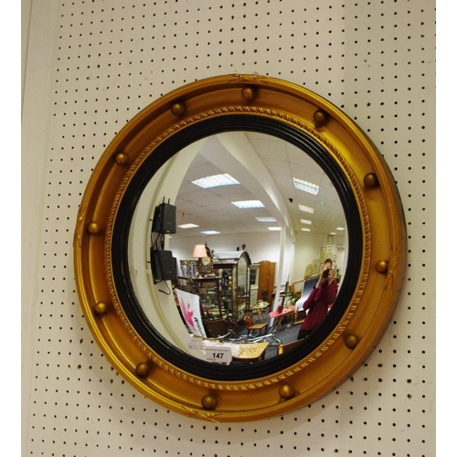 147 - A convex looking glass, gilt frame, ebonised inner border