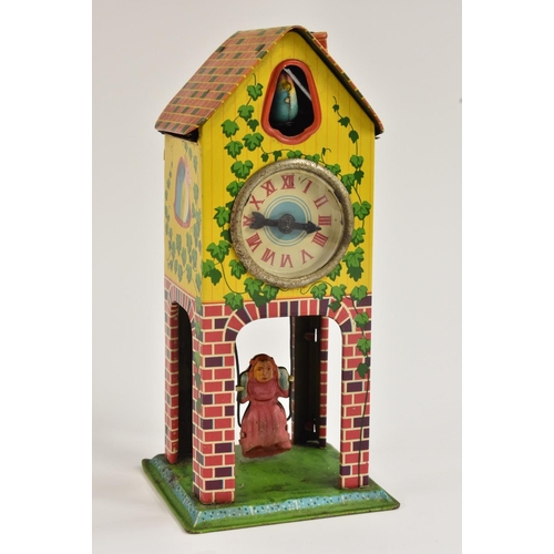 112 - A Japanese tinplate wind-up novelty clock, as a clock tower with cuckoo and girl in a swing,