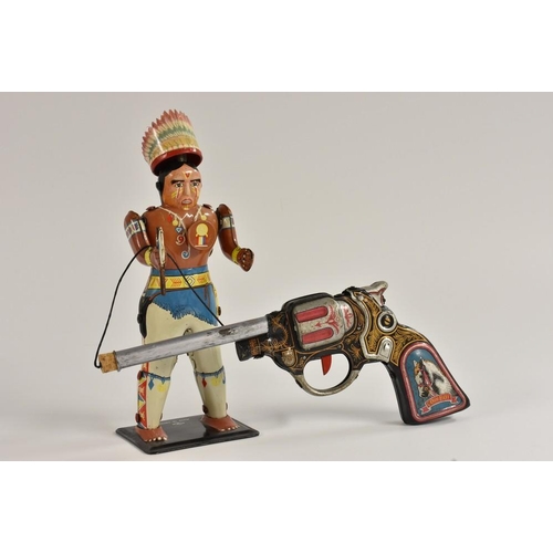 115 - A Japanese tin plate shooting game, with cowboy gun and Indian Chief, when shot, the Chief's hat and... 