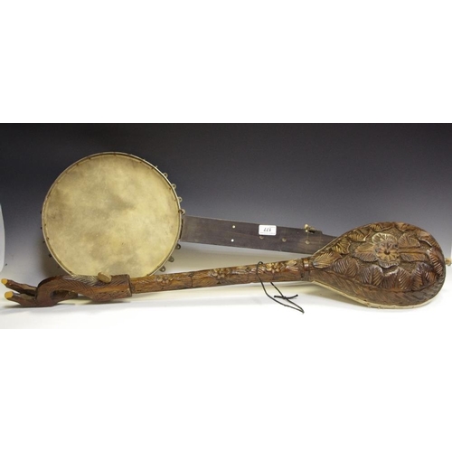 177 - An early/mid 20th century banjolelee; another instrument profusely carved throughout