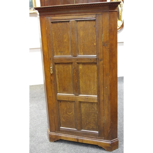 182 - An oak floor standing corner cupboard outswept cornice, six panelled door, associated back. 170cm hi... 