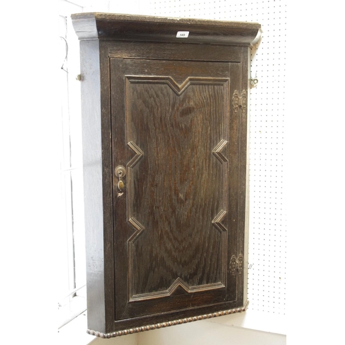 185 - A Jacobean revival oak block front corner cupboard.