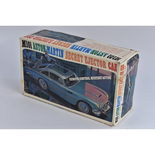 126 - Tinplate - an Aston Martin secret ejector car, M101, battery operated, with remote control, in origi... 