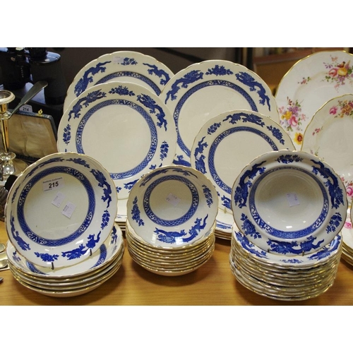 215 - A Royal Cauldon dinner service, transfer printed in blue and white with dragons in the Chinoiserie t... 