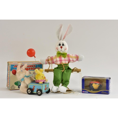 145 - A Japanese Jolly bunny cub carriage, windup, tinplate and plush; a Corgi Cadburys Creme Egg car, in ... 