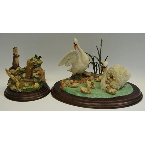 219 - A Country Artist family group model CA506 swans, another cast, 68 Otter, with waterfall,  (2).