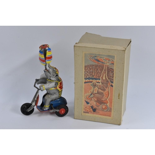 150 - A West German tinplate, Elephant on Cycle, made in US Zone, windup toy, in original box; a pull alon... 