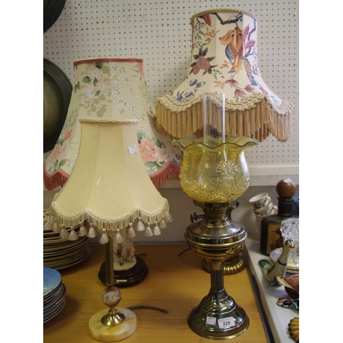 225 - An early 20th century brass oil lamp, amber glass shade, a substantial gilt metal lamp base, with sh... 