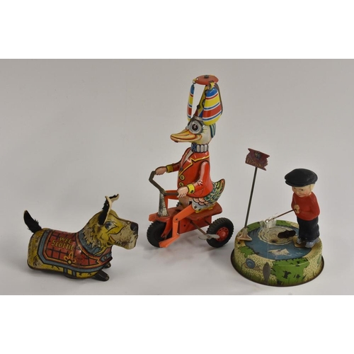154 - A Marx tin plate Scotty Dog, windup toy; Fishing Boy, made in Great Britain; Windmill duck riding a ... 