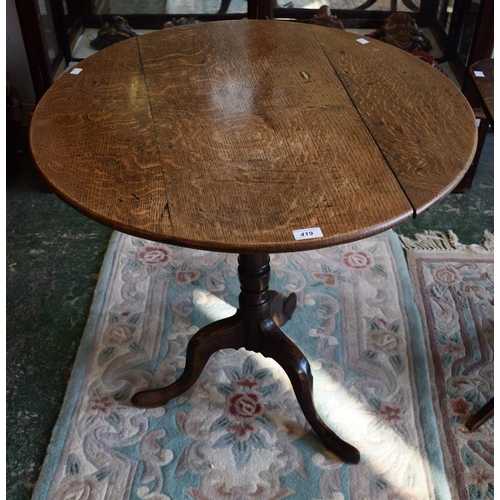 419 - A 19th century oak near-circular occasional table, three piece tilting top, turned spreading column,... 