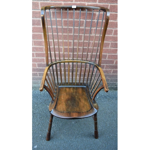 421 - A 19th century elm wingback Windsor elbow chair, or unusual proportions, saddle seat, shallow ring t... 