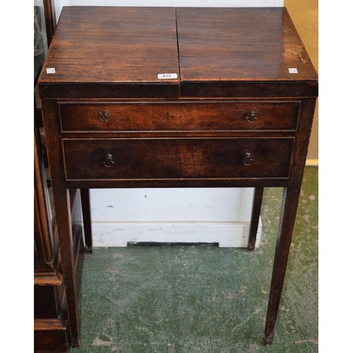 425 - A 19th century mahogany washstand/work table, double hinged top enclosing an arrangement of open and... 