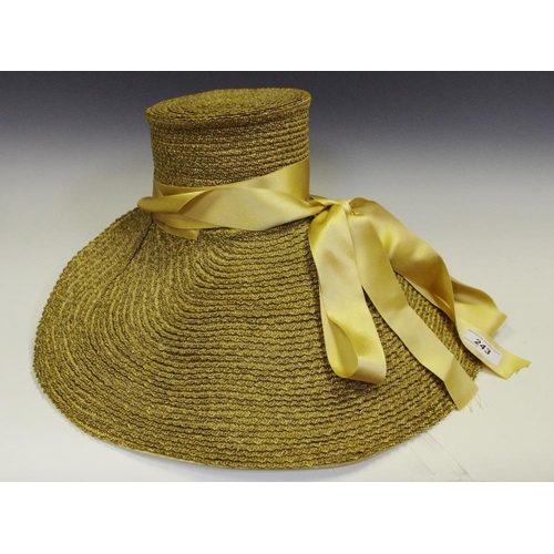 243 - A lady's straw bonnet, tied with gold silk and gold ribbon tie.