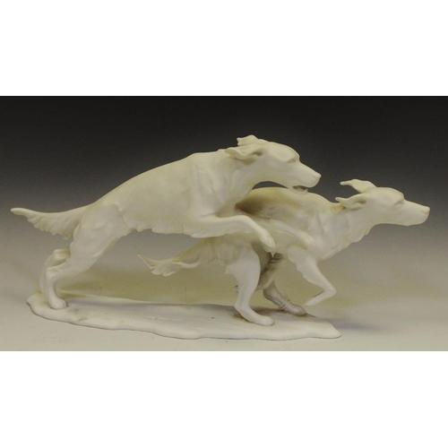 246 - A Kaiser porcelain model of two bounding dogs, signed G. Bochmann