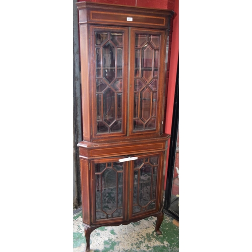 437 - A George III Revival floor standing corner display cabinet, outswept cornice above a pair of astraga... 