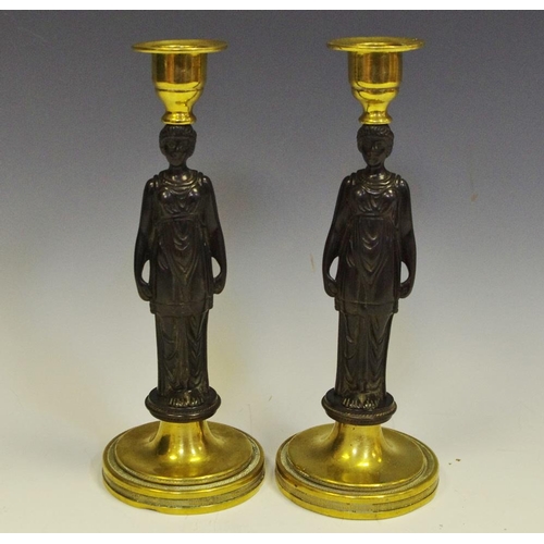 255 - A pair of Grecian Revival dark and gilt patinated bronze figural candlesticks, Erechtheion caryatids... 