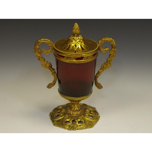 256 - A 19th century French gilt-metal mounted ruby glass vase and cover, cylinder reservoir, scrolling tw... 