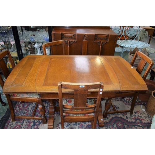 440 - A 20th century oak drawer-leaf dining table; a set of four conforming dining chairs; a similar sideb... 