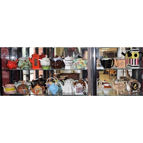 443 - Novelty ceramic teapots including telephone box, radio, paint pot, golf ball, Red Baron, champagne b... 