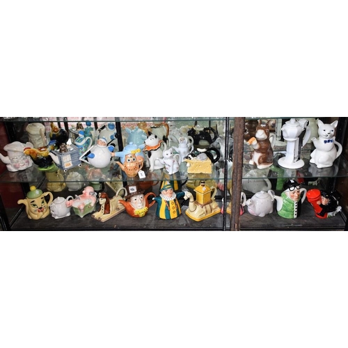 445 - Novelty ceramic teapots including sphinx, rabbit, cat, Punch, Mad Hatter, postman, skier, etc, vario... 