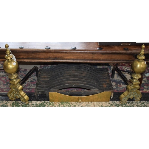 450 - A pair of Louis XIV Revival brass andirons; cast metal fire grate; brass ash pan front (4)