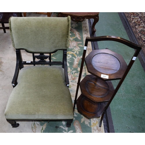 460 - An ebonised nursing chair; a 20th century oak three-tier folding cake stand (2)