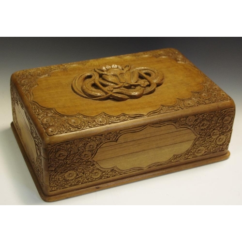 279 - An early 20th century Sandalwood jewellery box, central tribal carving, surrounded by floral border,... 