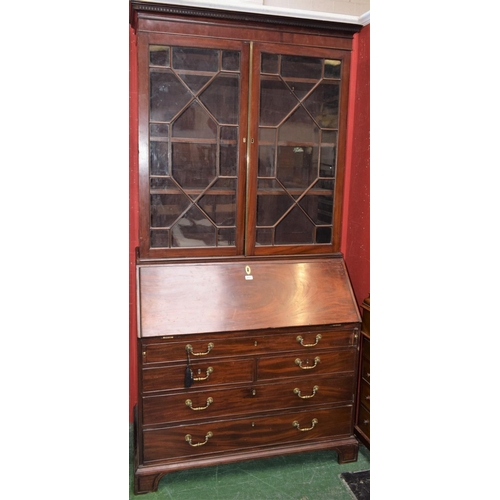 471 - A 19th century mahogany bureau bookcase, outswept dentil cornice above a pair of glazed doors enclos... 