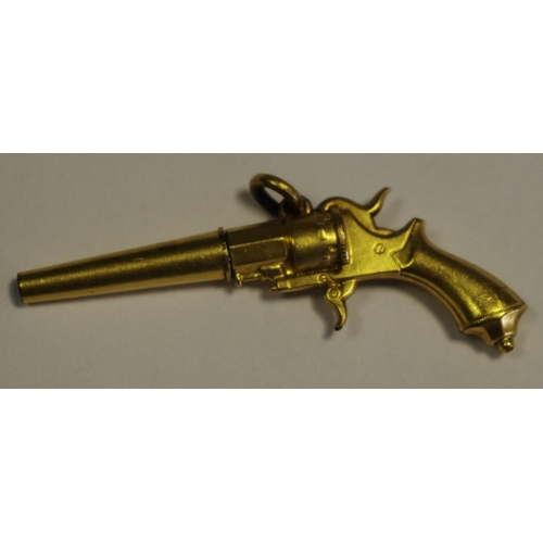 292A - An early 20th century yellow metal novelty pocket watch winder, in the form of a revolver... 